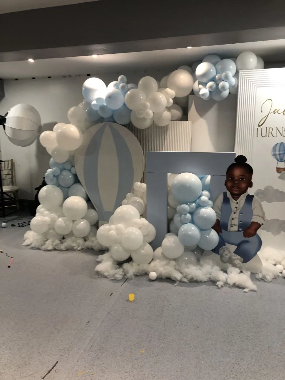 Blue and white hot air balloon backdrop for a first birthday at P2 Centre, Erith