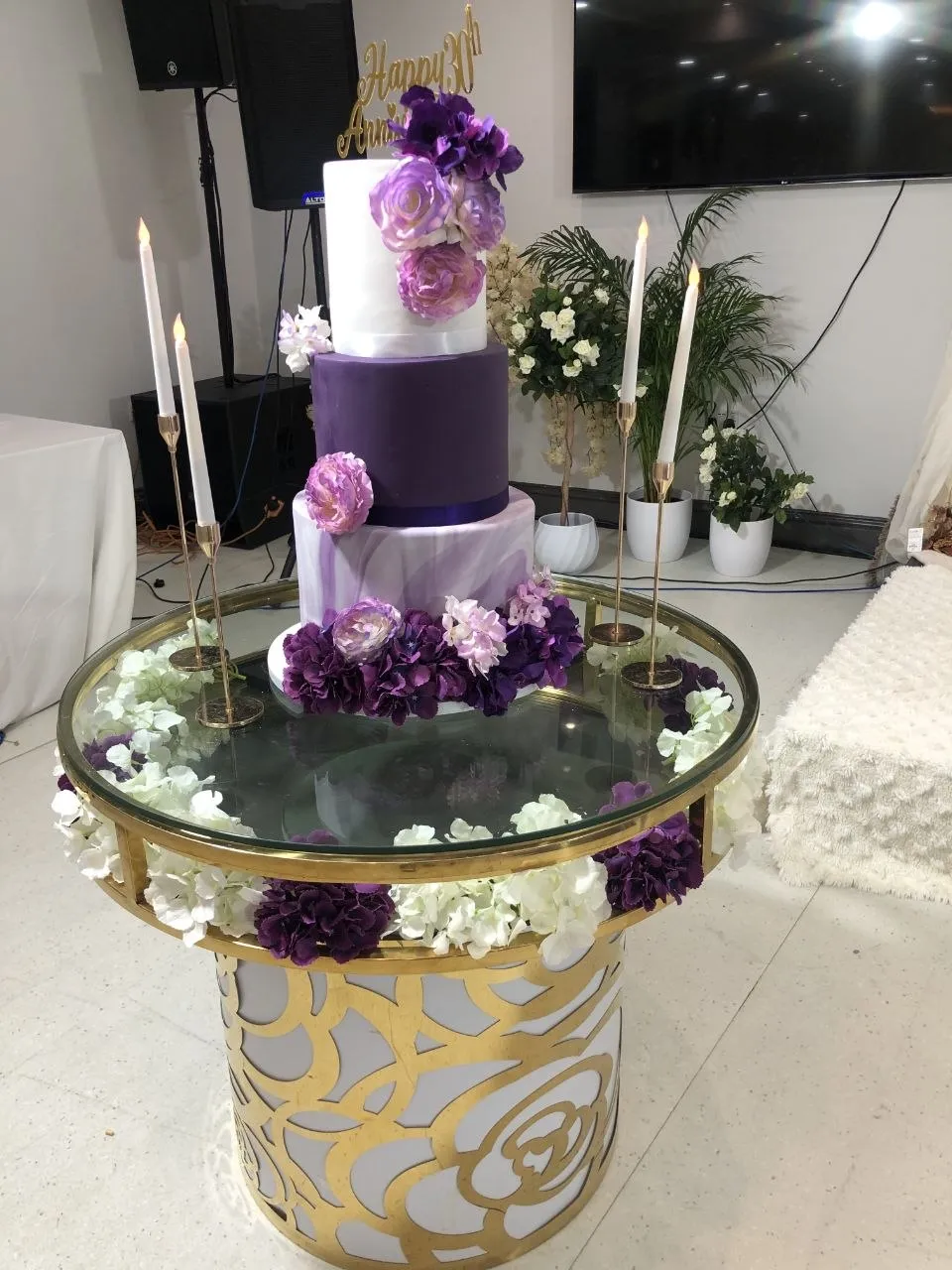 Purple and white 30th anniversary cake on a gold and glass cake table at P2 Centre, Erith