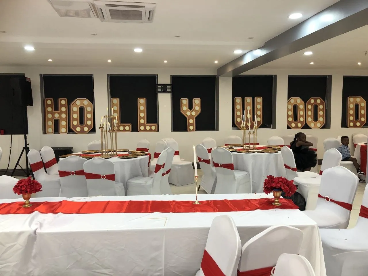Hollywood-themed party with marquee letters and red and white table styling at P2 Centre, Erith