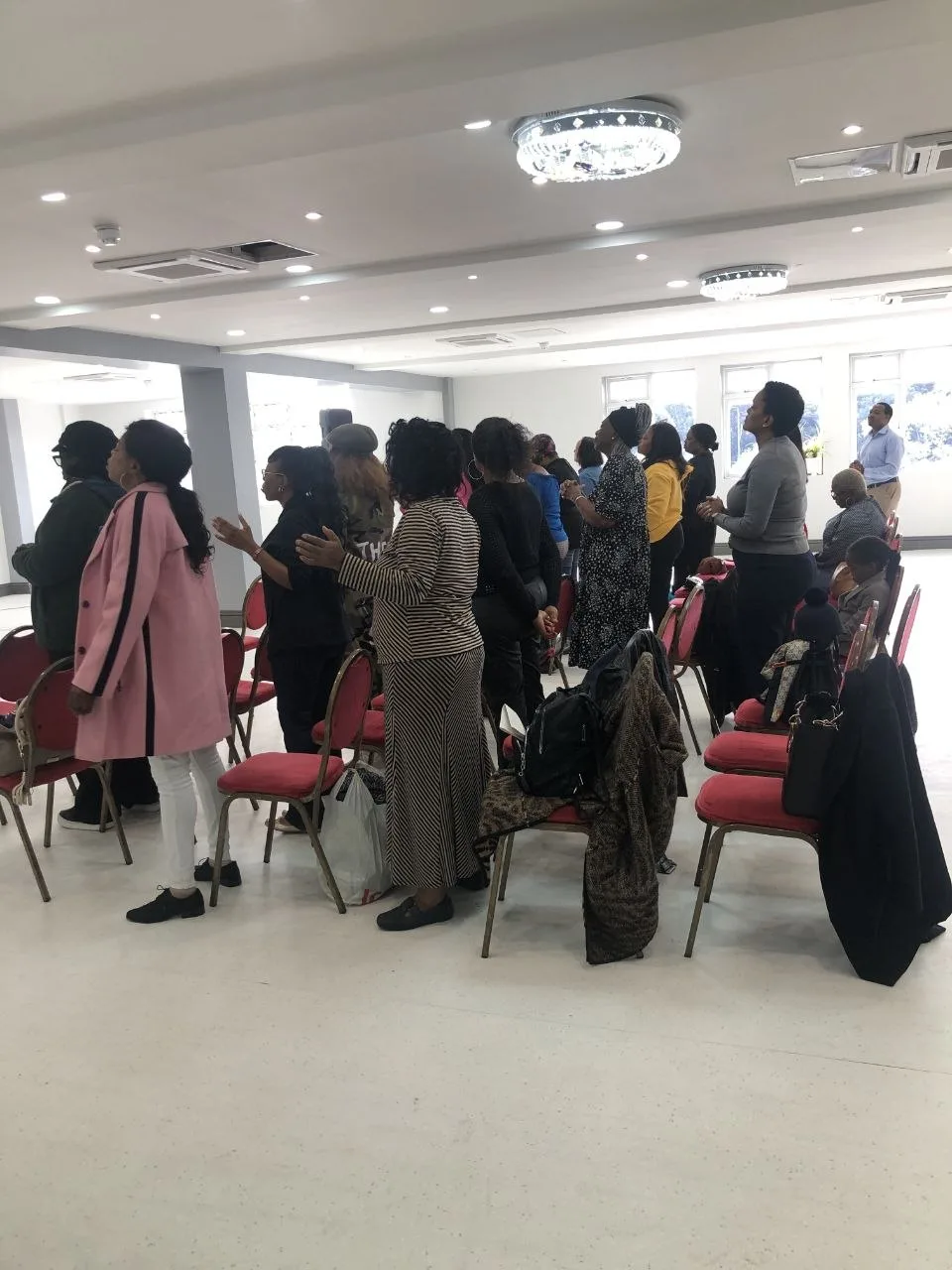 Church congregation in worship at the P2 Centre hall in Erith