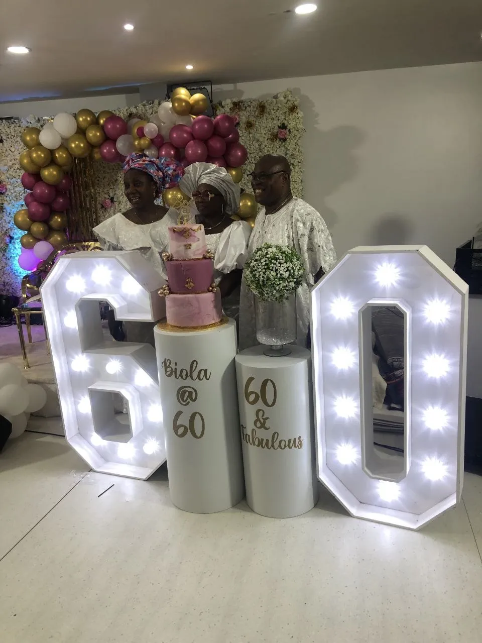 60th birthday celebration with pink and gold balloons, light-up numbers and family at P2 Centre, Erith