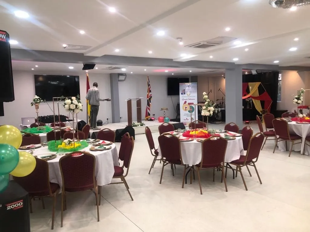 Community celebration with round tables and red, yellow and green decorations at P2 Centre, Erith