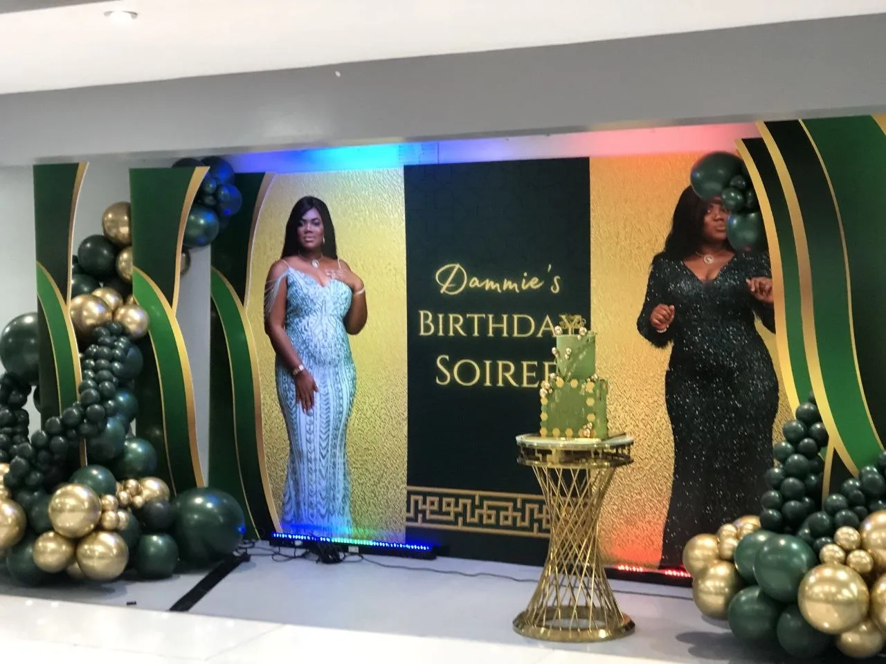 Green and gold birthday stage with balloon garlands and a portrait backdrop at P2 Centre, Erith