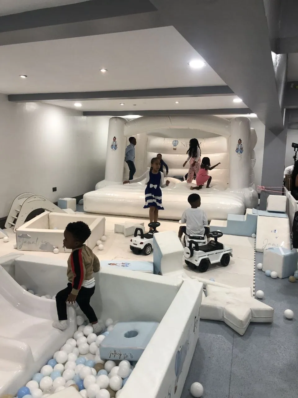 Soft play, bouncy castle and ride-on cars set up for a first birthday party at P2 Centre, Erith