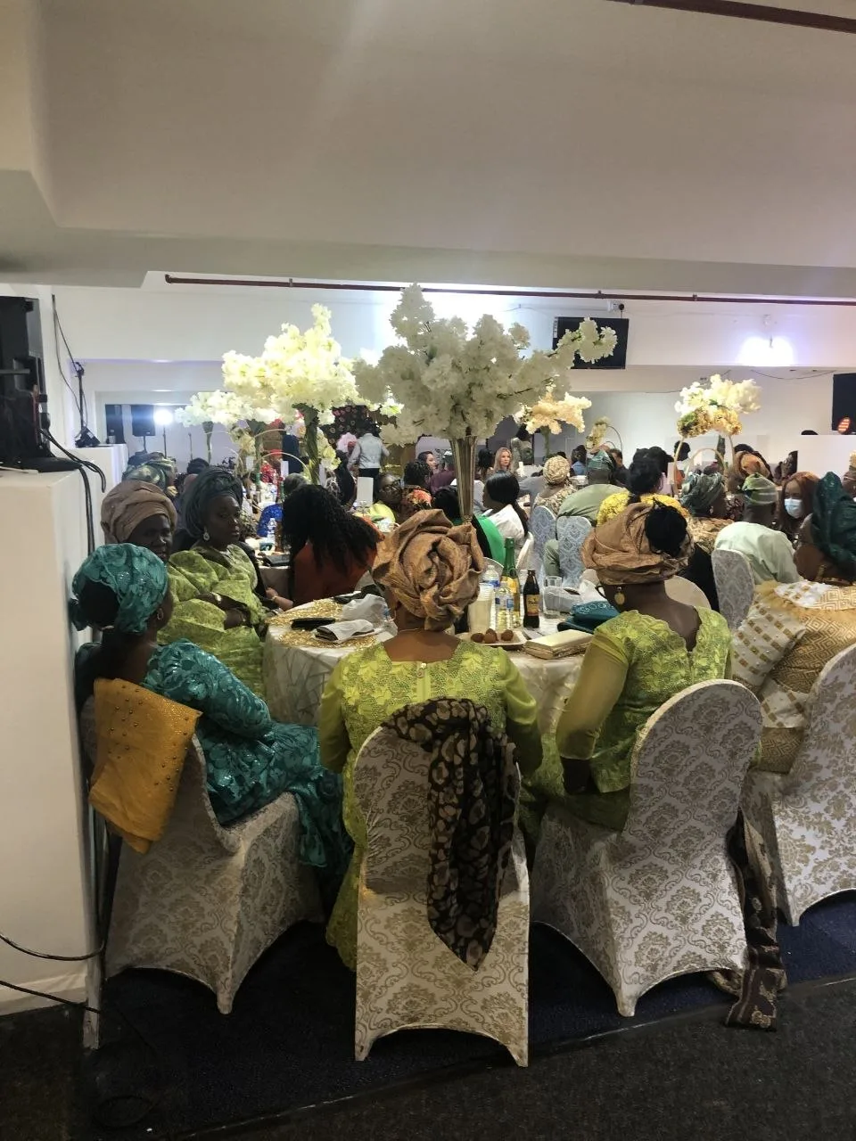 Guests in traditional dress celebrating at a party in the P2 Centre function room, Erith
