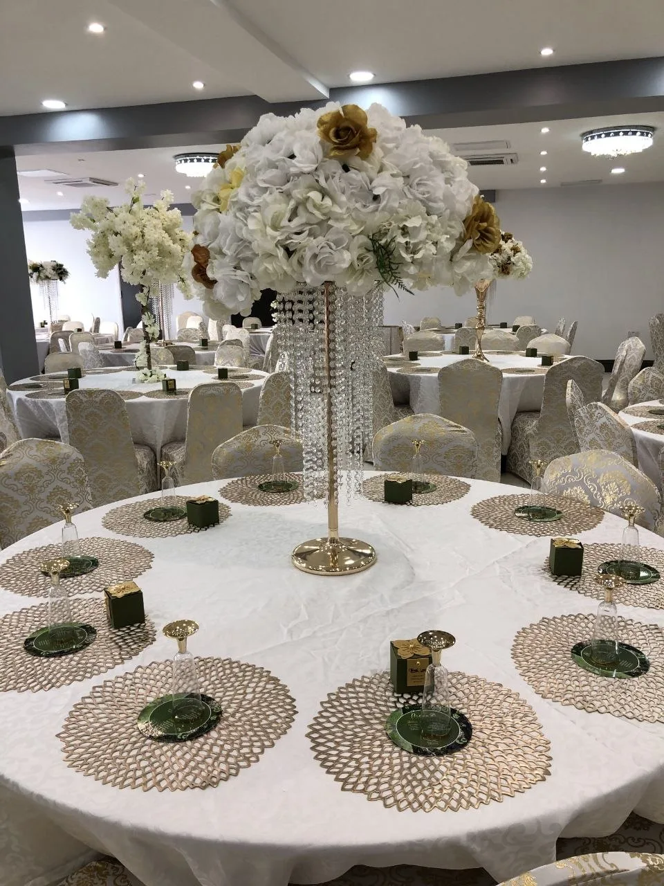 Gold placemats and crystal floral centrepiece on a banquet table at P2 Centre, Erith