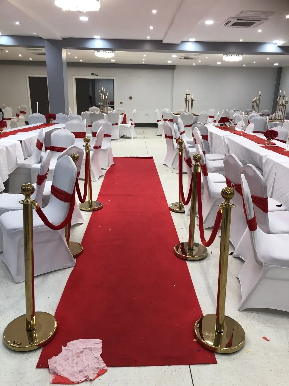 Red carpet entrance with gold rope barriers at a party in the P2 Centre hall, Erith