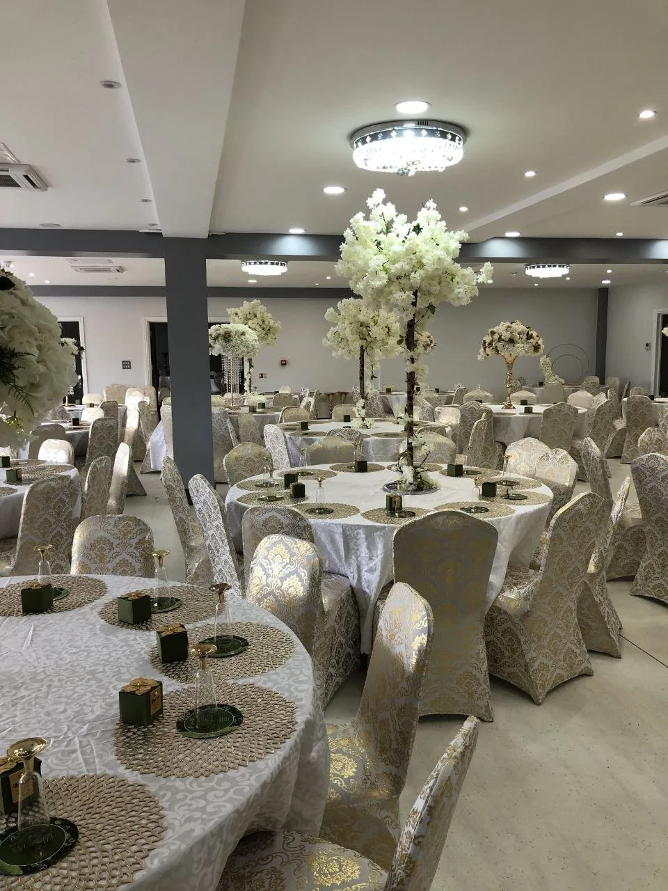 P2 Centre event hall in Erith dressed with blossom trees, chandeliers and gold damask chairs